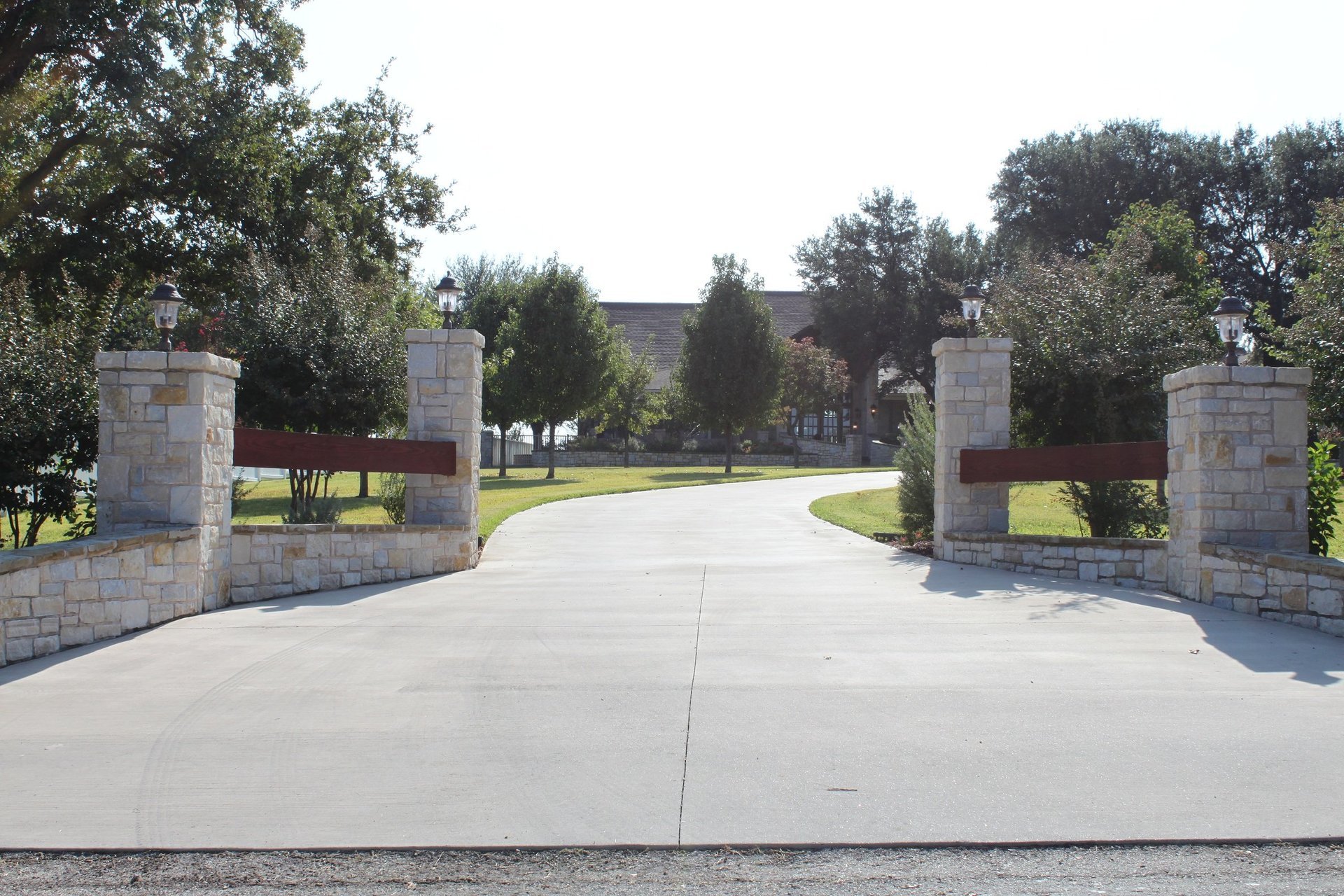 Elegant limestone gate entrance to a Tincher's custom estate home in West Texas