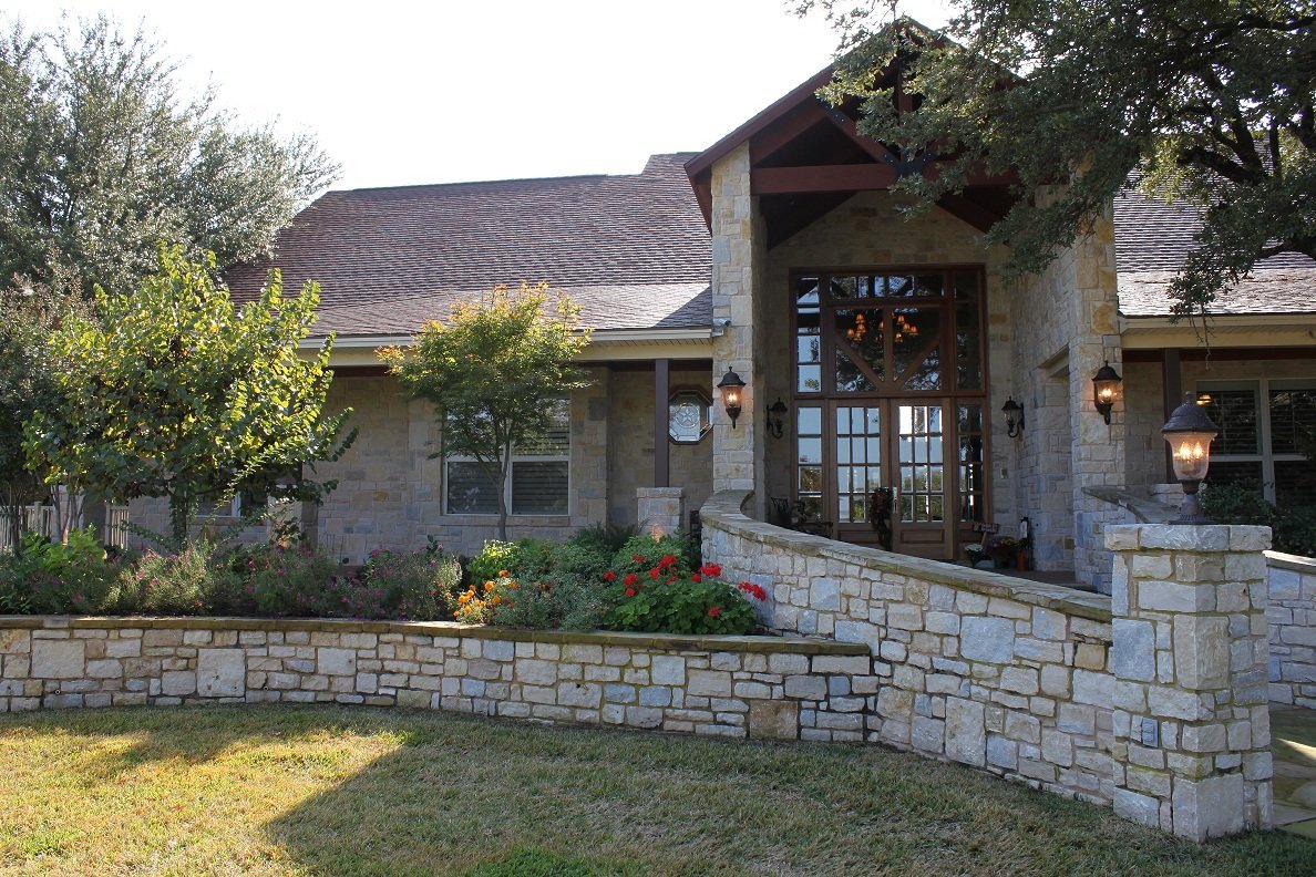Custom Texas limestone home with covered porch and mature landscaping — Tincher's Custom Homes Mineral Wells