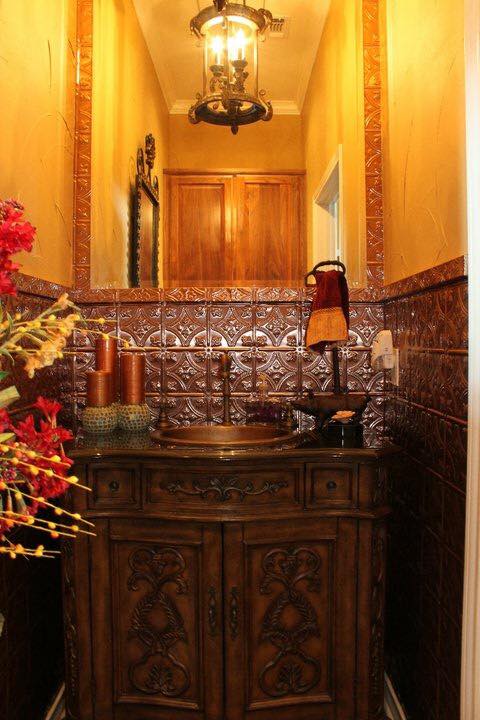 Ornate powder room remodel with antique copper vessel sink and pressed tin tile — Tincher's Custom Homes